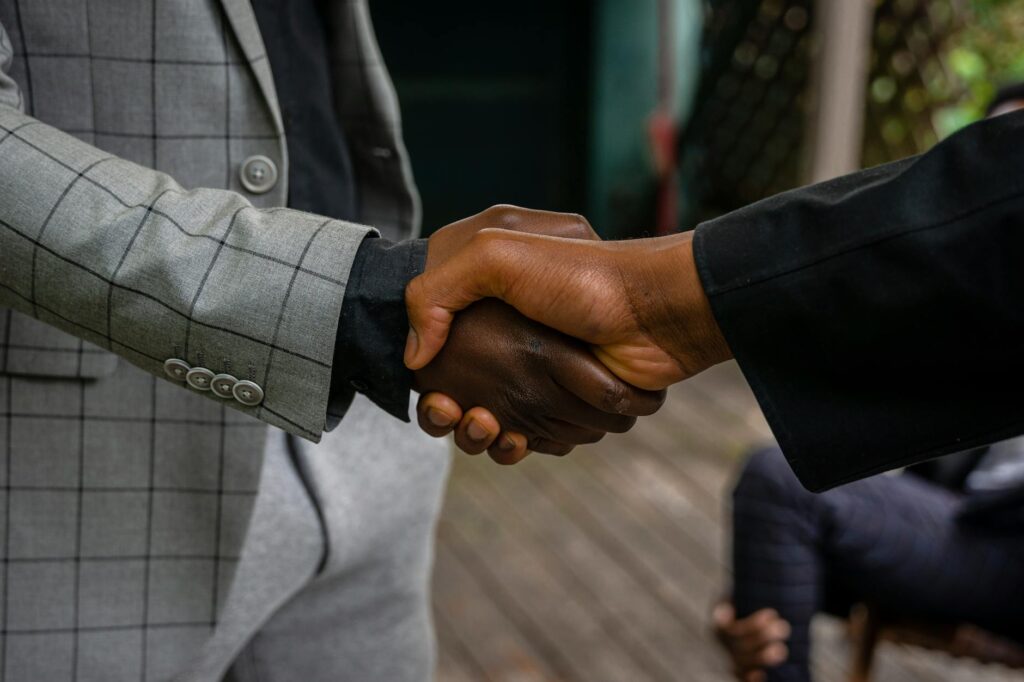 pexels photo 8276364 8276364 Close-up of two professionals shaking hands, symbolizing success and partnership.